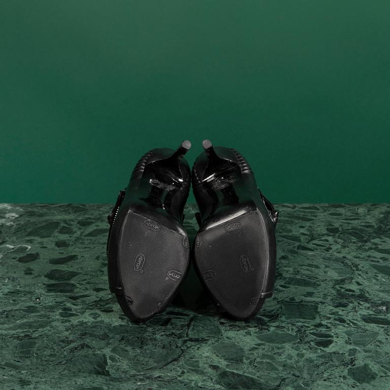 A pair of BOOTS by ALEXANDER MCQUEEN, in size 37.