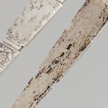 An English 18th century silver ladle, a silver tumbler and two silver sugar-tongs.