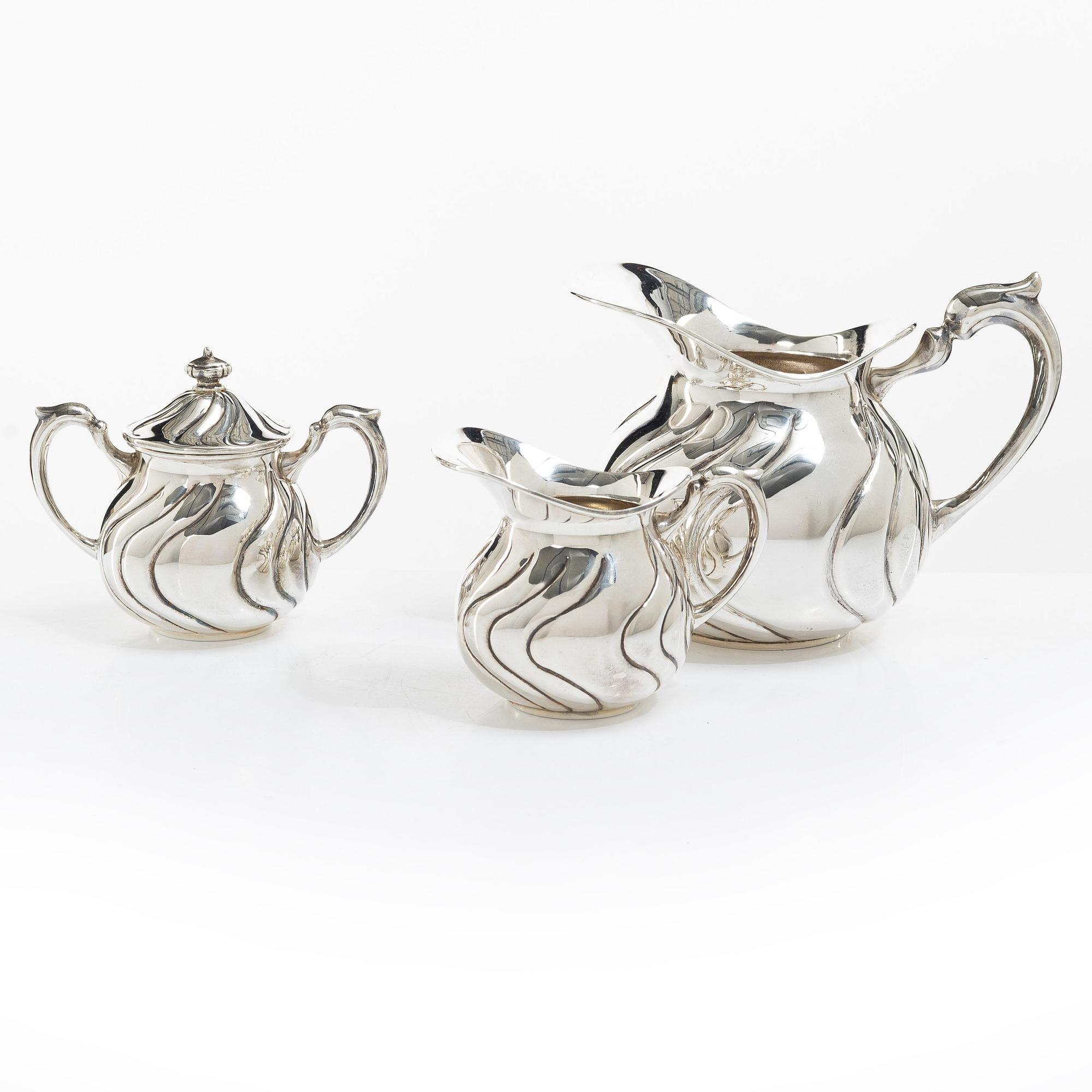 A sterling silver jug, milk jug and sugar bowl, possibly Mexico, mid20th century.
