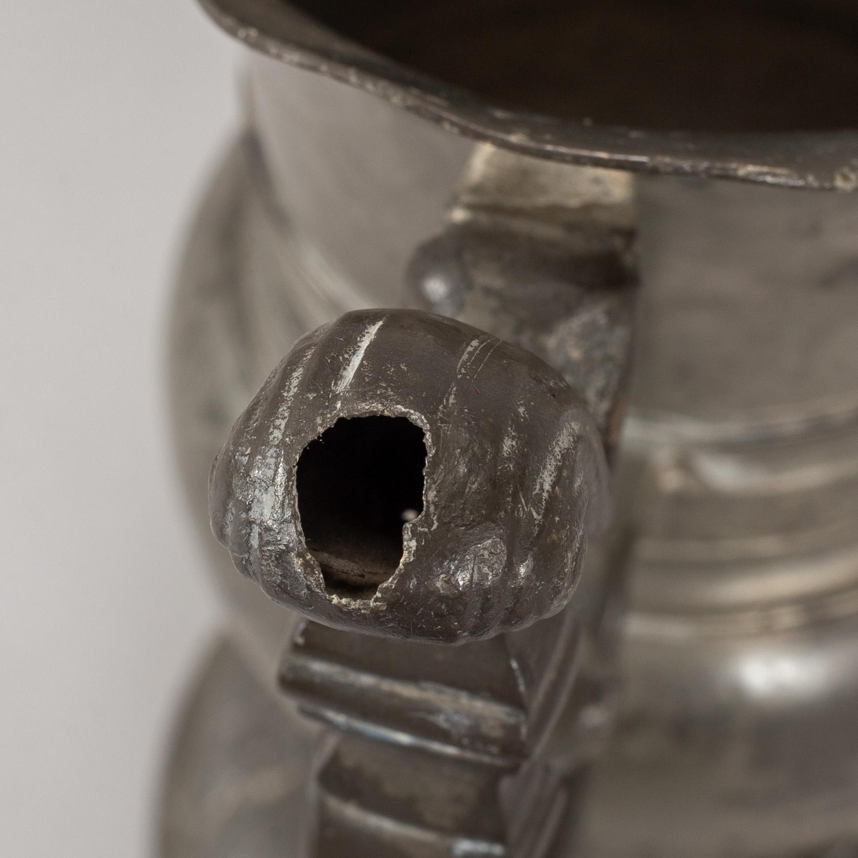 A pewter jug, probably 17th century.