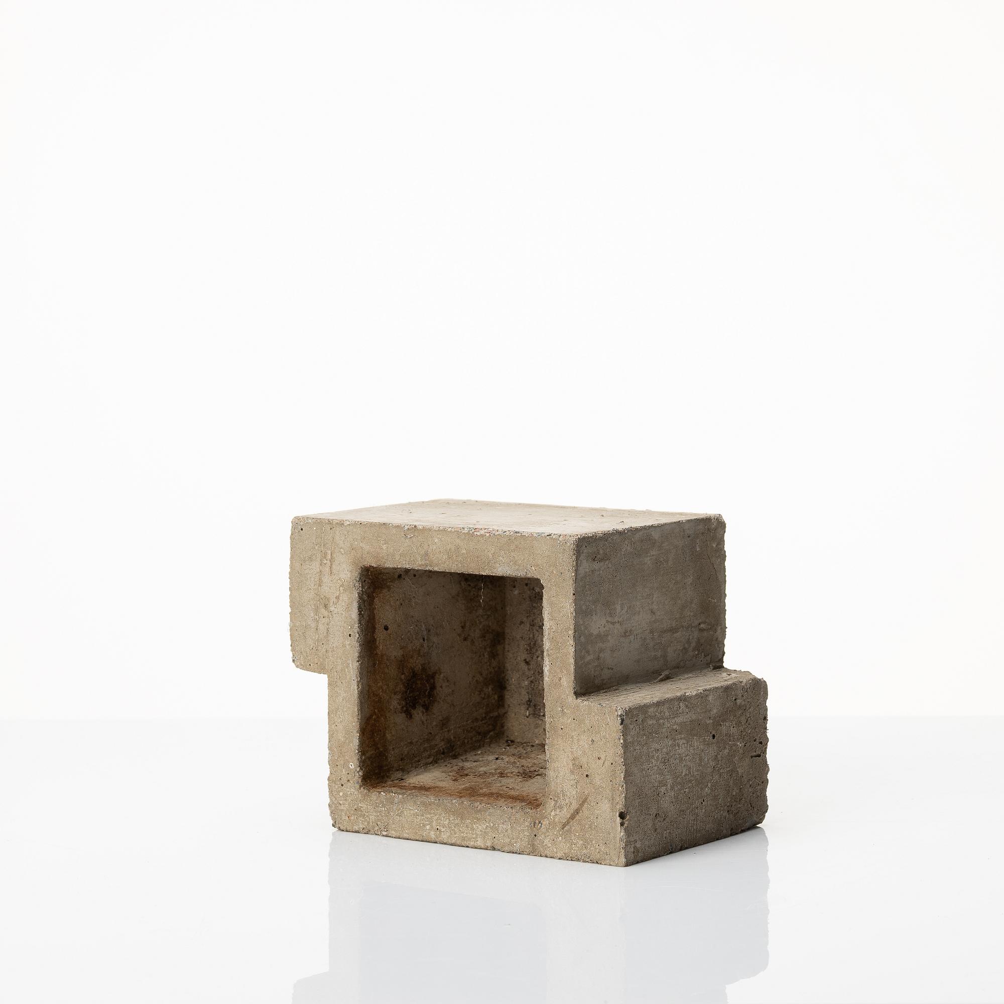 Stina Lindholm, a contemporary concrete planter 'Spira', a concrete flower pot and a wall clock.
