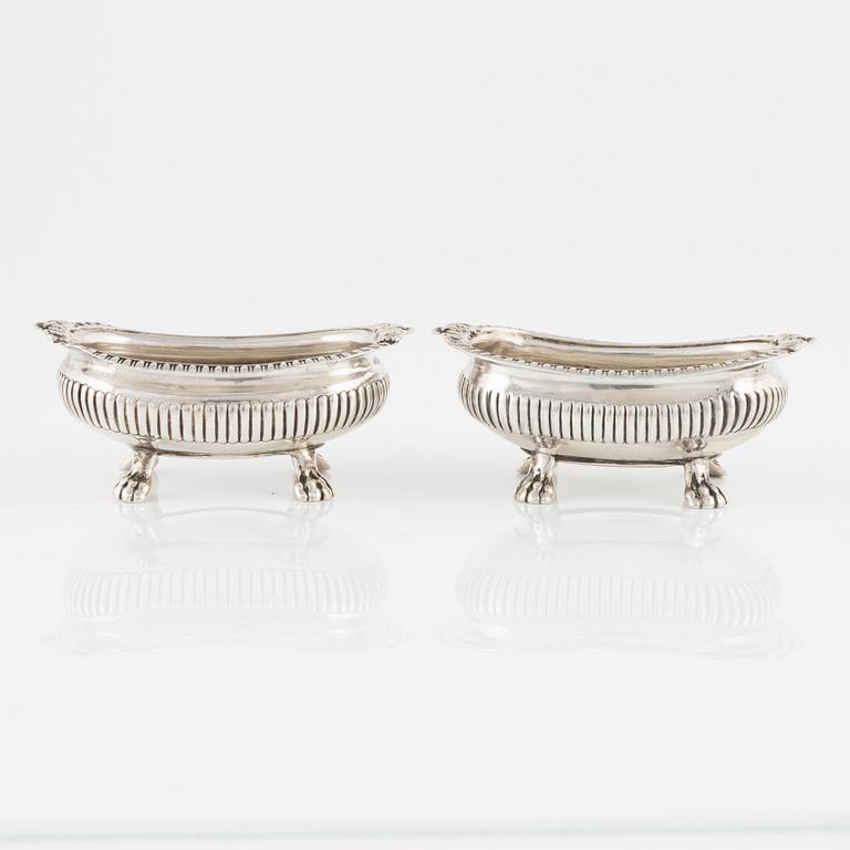 A pair of English Silver Salt Cellars, marks ofJoseph Angell Il 1823 and Samuel Dutton 1826 respectively, London.