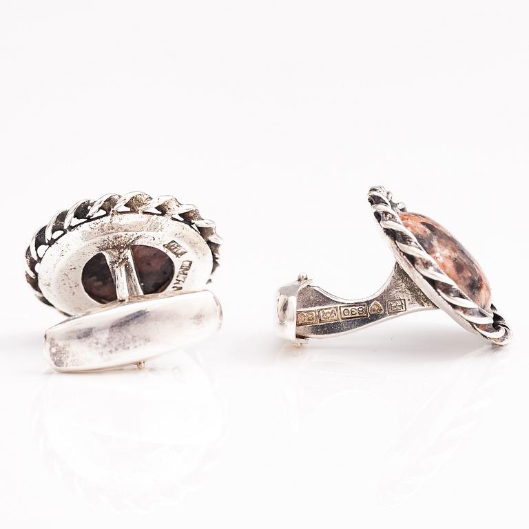 A set of three pairs of silver cufflinks with hematite, tigers eye and granite. Turun Hopea and Osvald Mättö.