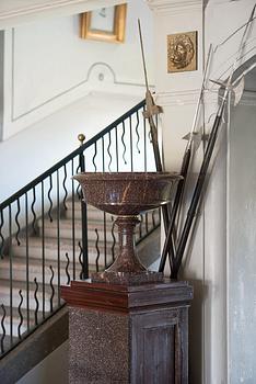 A pair of Swedish porpyry vases on wooden bases, Älvdalen, first half of the 19th century.