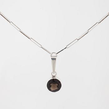 GERT THYSELL, Gussi, Malmö, 1967, a faceted smoky quartz pendant.