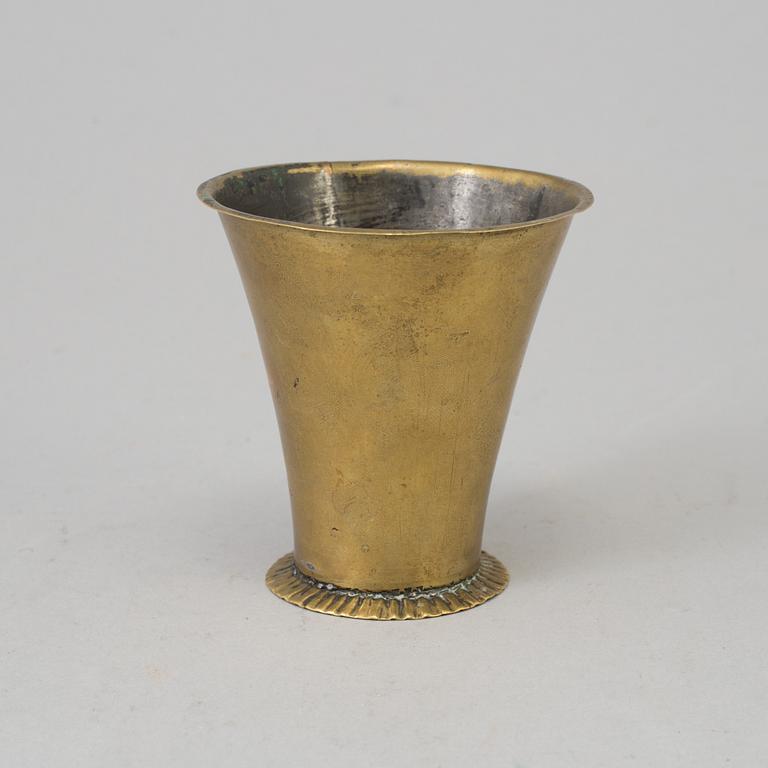 An 18th century brass beaker.