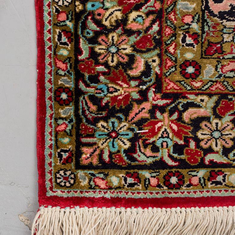 A silk Qum rug, around 114 x 80 cm.
