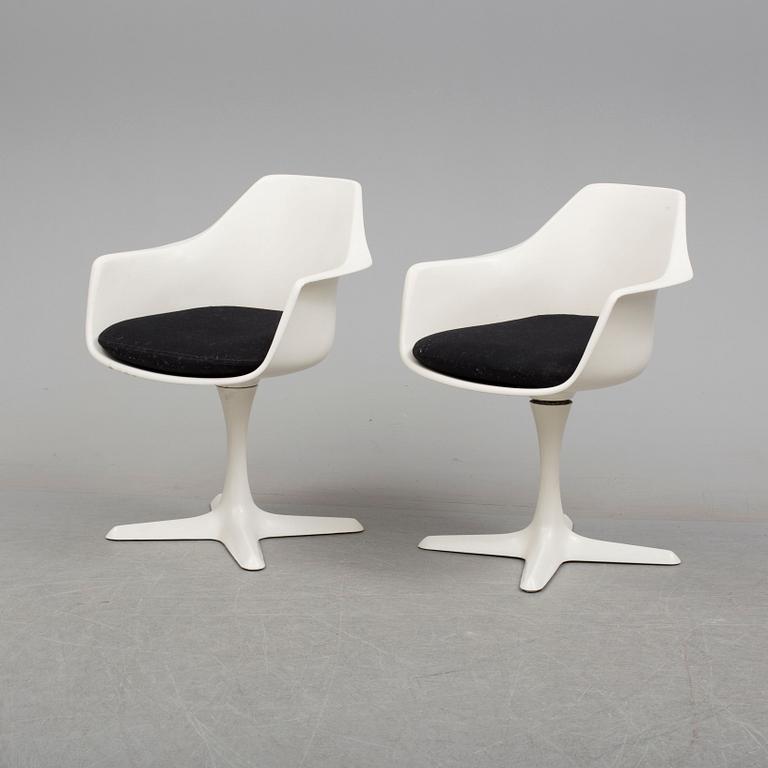 A dining table and eight chairs by Robin Day, Arkana.