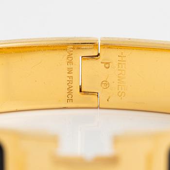 Hermès, a 'Clic H' bracelet.