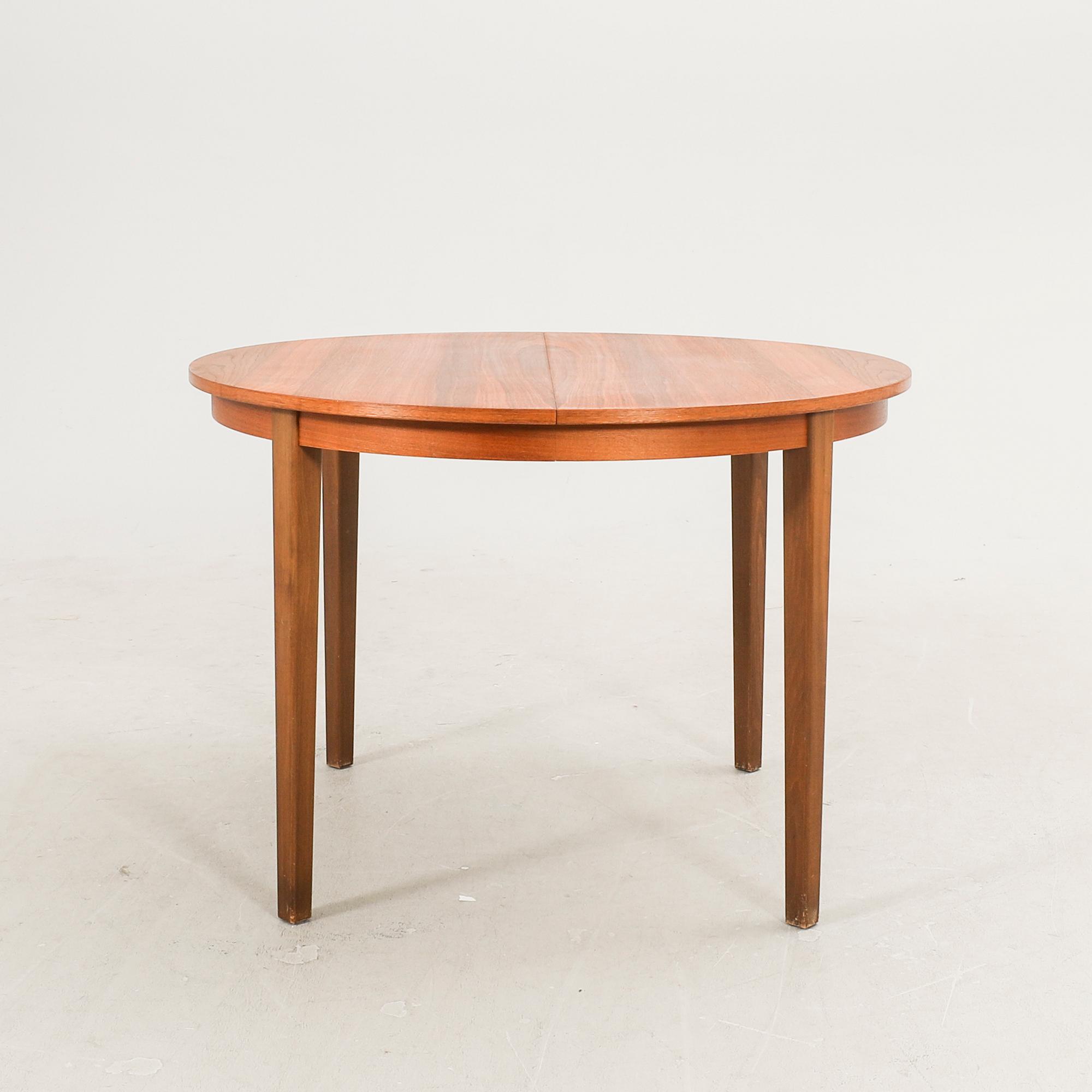 A 1960s walnut dining table.