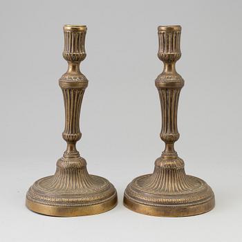 A pair of late 18th century bronze candlesticks.