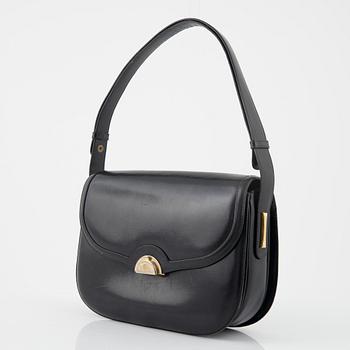 Gucci, a black leather bag.