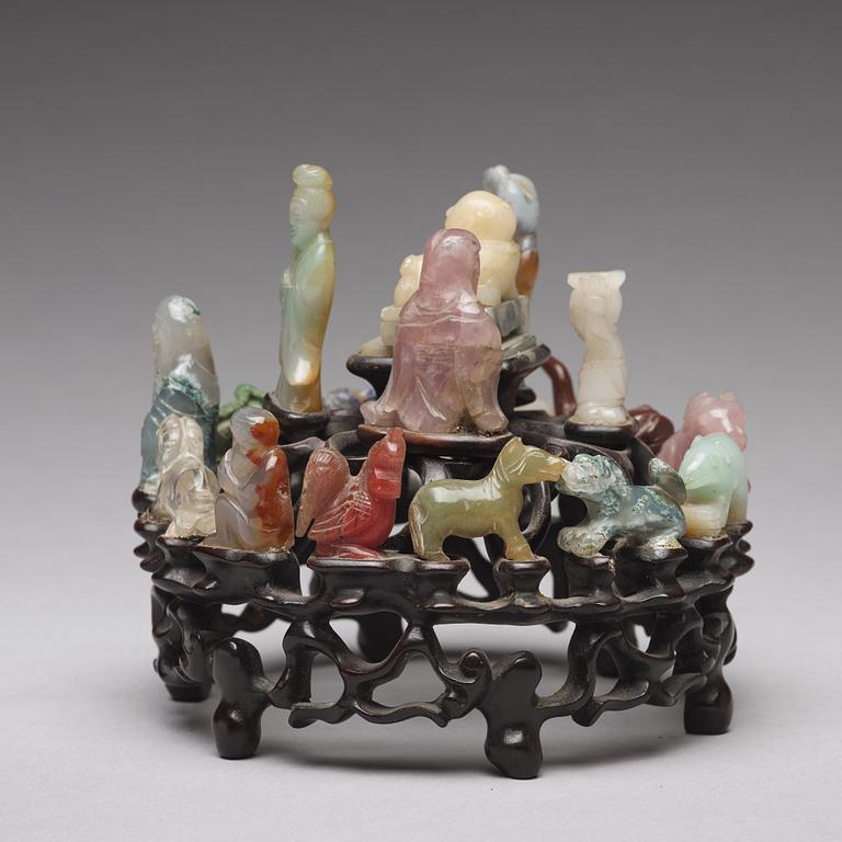 An arrangement of stone sculptures on a wooden stand, China 20th Century.