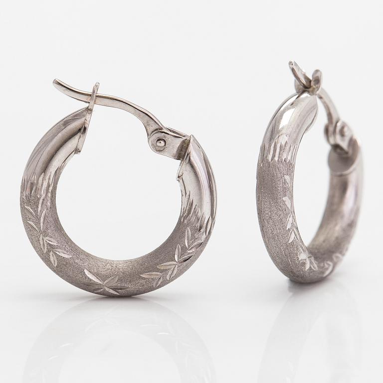 A pair of 14K white gold earrings.