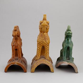 A group of three Chinese glazed roof tiles of seated animals, 20th century.