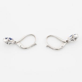 A pair of 18K gold earrings with faceted sapphires and round brilliant-cut diamonds.