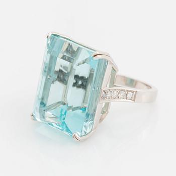 An 18K white gold ring set with a step-cut aquamarine.