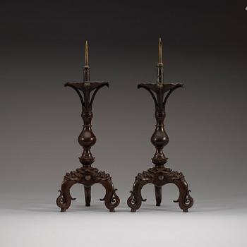 A pair of bronze candlesticks, presumably Ming dynasty (1368-1644).