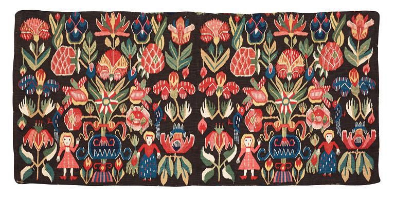 CARRIAGE CUSHION, tapestry weave. "Flower cushion with stylized vases and people". 47 x 101 cm. South of Scania, Sweden, the second half of the 18th century til early 19th century. Probably Torna district.