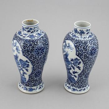 A pair of blue and white vases, Qing dynasty, late 19th century, with a Kangxi mark to the base.