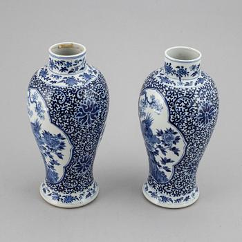 A pair of blue and white vases, Qing dynasty, late 19th century, with a Kangxi mark to the base.