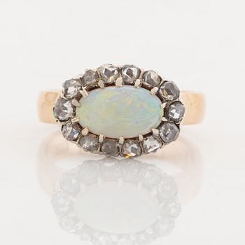 An 18K gold and opal ring set with rose-cut diamonds.