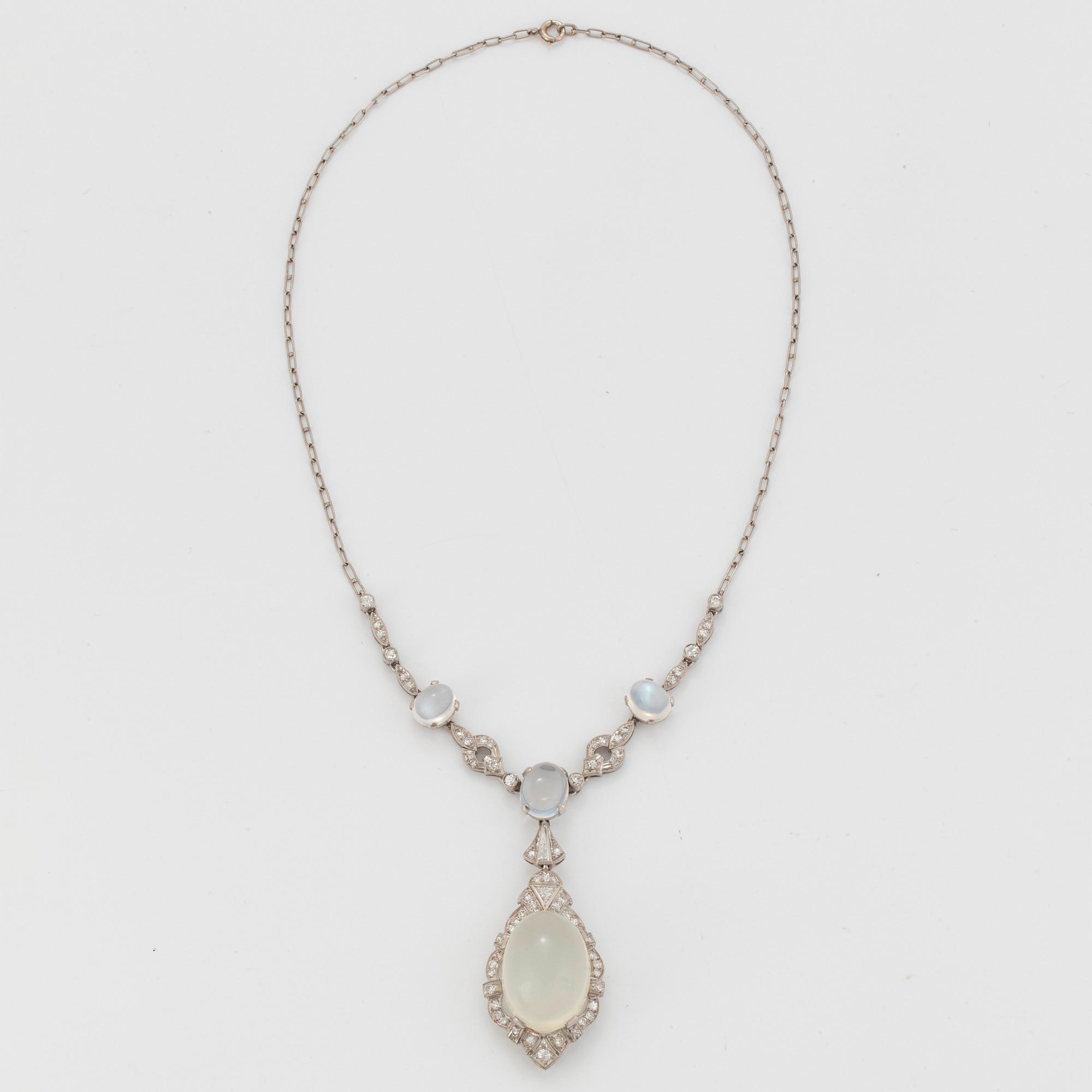 A platinum necklace set with moonstones and old- and eight-cut diamonds.