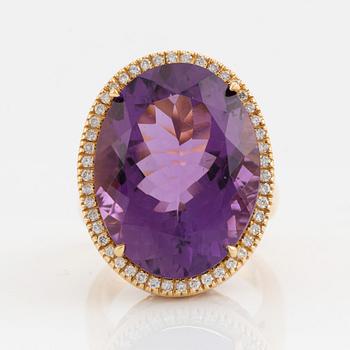 Oval faceted amethyst and brilliant cut diamond cocktail ring.