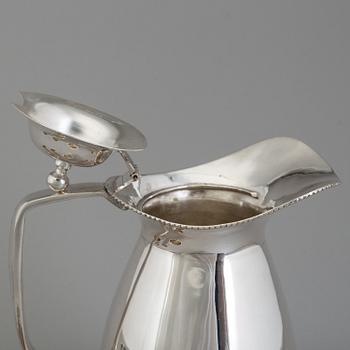 a 5-piece set of a silver jug and four silver glasses.