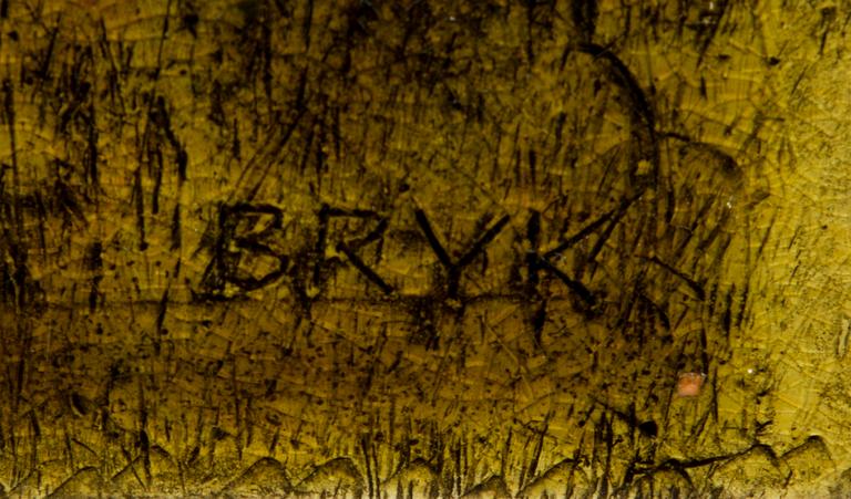 A ceramic relief, signed Bryk.