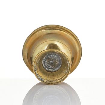 A bronze deity and a brass sacrificial bowl, Tibet, circa 1900.