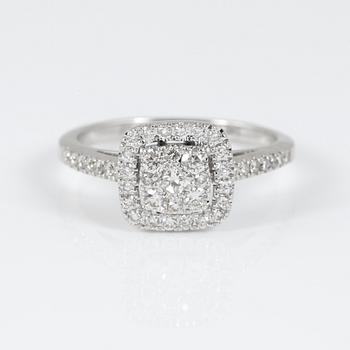RING, 14K vitguld med central prinsesslipad diamant omgiven av briljantslipade diamanter tot ca 0,71 ct. Vikt 3,22 g.