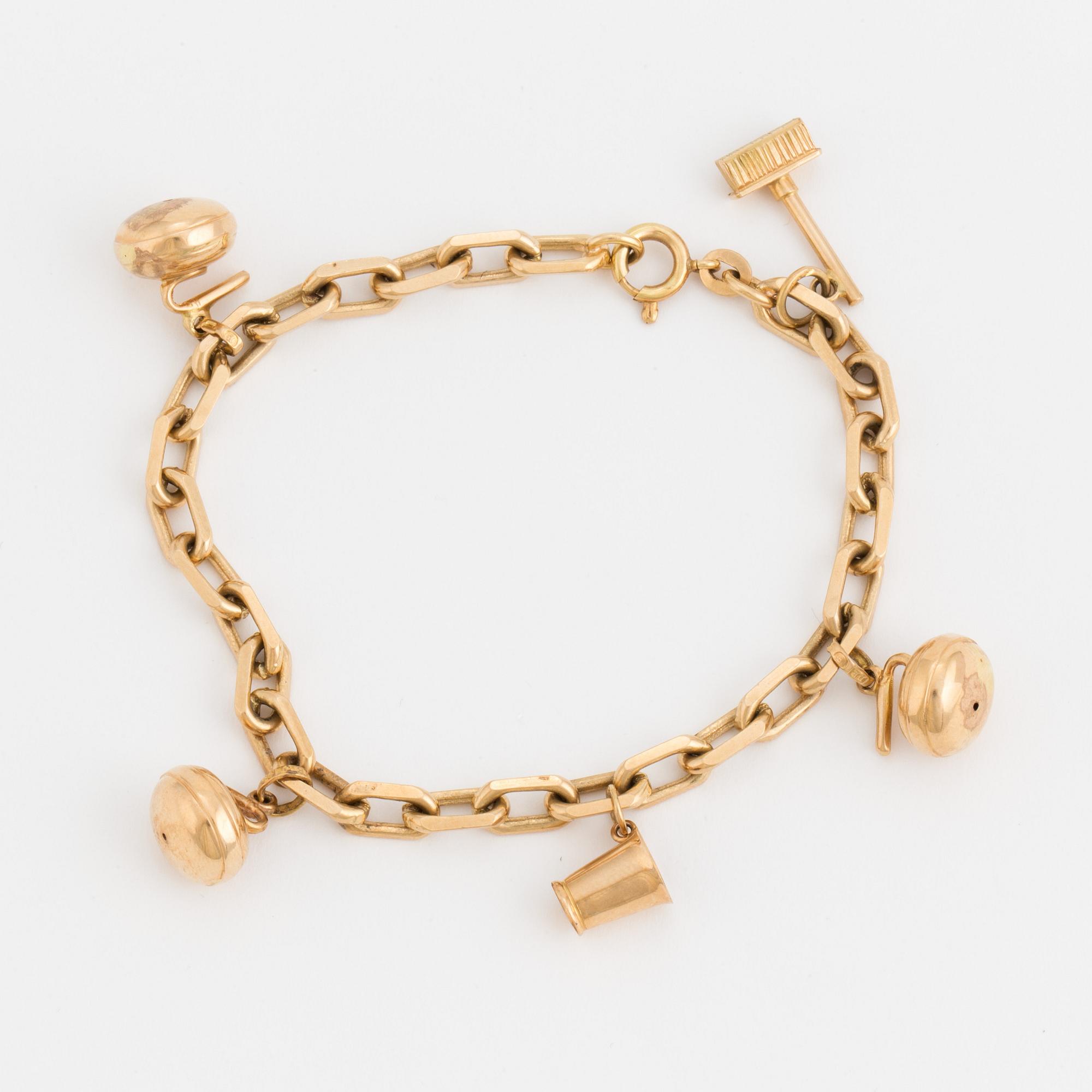 An 18K gold, cable-link charm-bracelet.