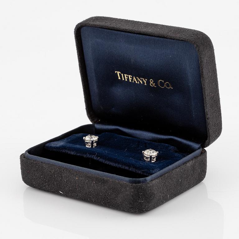 A pair of earrings in 18K white gold set with two round brilliant-cut diamonds, likely Tiffany & Co.
