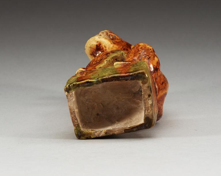 A potted figure of a 'Buddhist Lion', Tang dynasty (618-907).