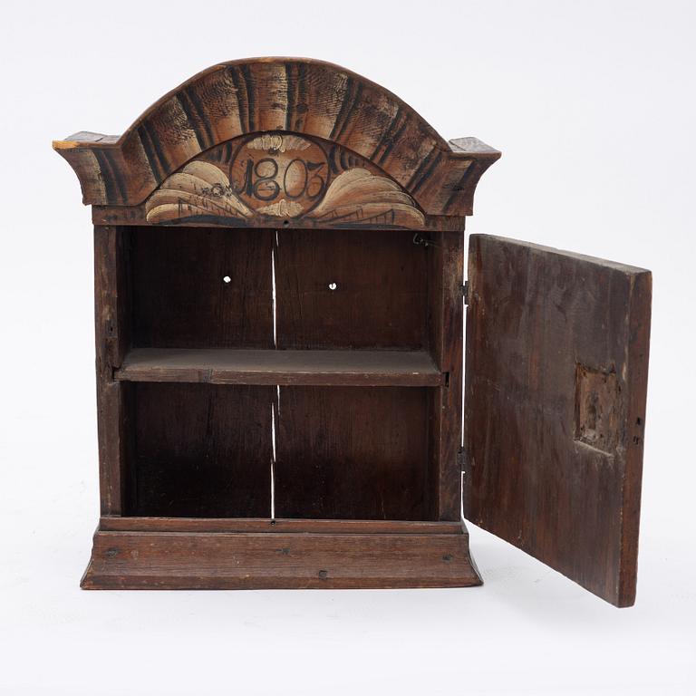 A Swedish wall cabinet, dated 1803.