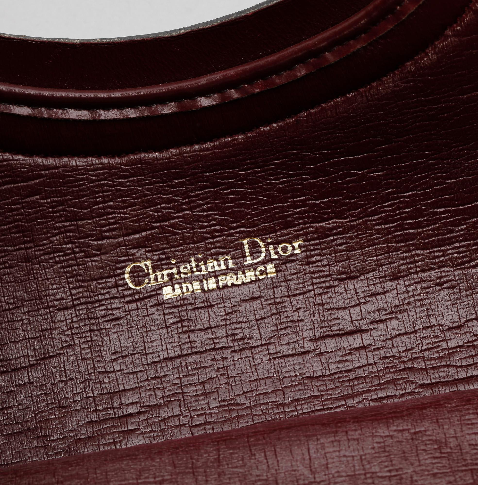 A red monogram canvas handbag by Christian Dior.