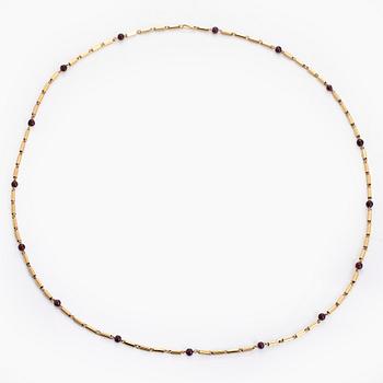 A 16K gold necklace with garnets.