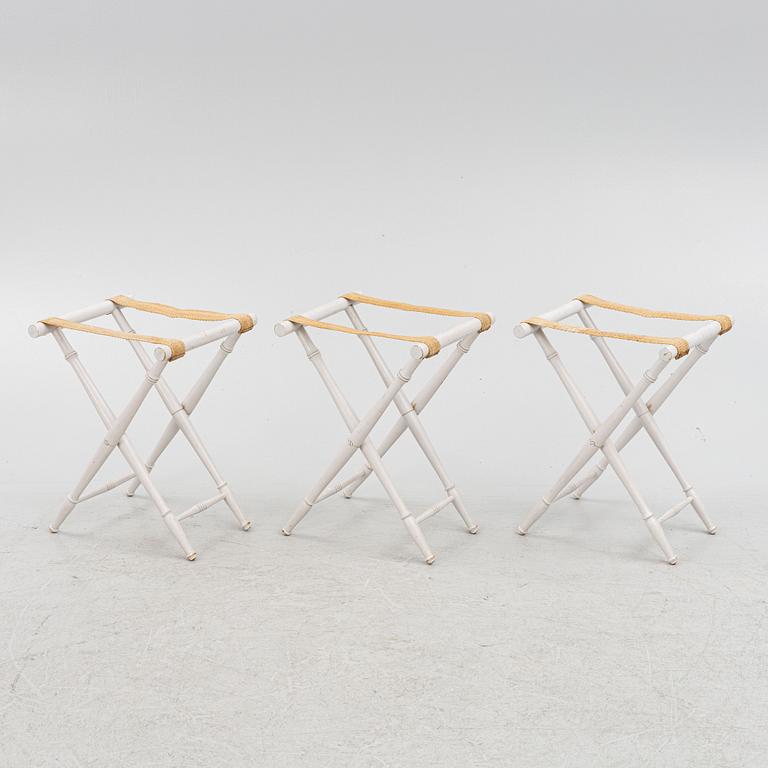A set of three luggage stands, 20th century.