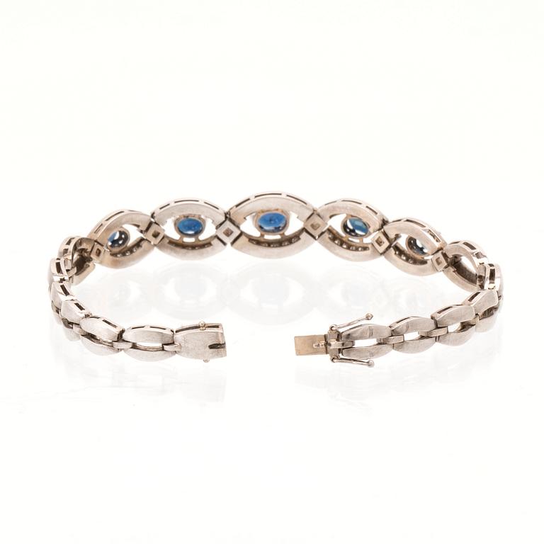 An 18K white gold bracelet set with oval faceted sapphires and brilliant-cut diamonds, Stockholm.