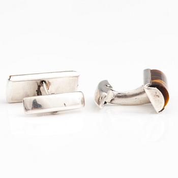 A set of three pairs of silver cufflinks with hematite, tigers eye and granite. Turun Hopea and Osvald Mättö.
