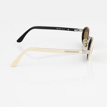Dolce & Gabbana, a pair of white sunglasses.