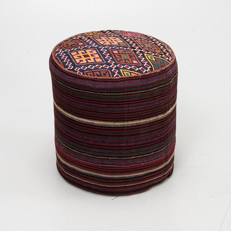 A Kelim covered stool.