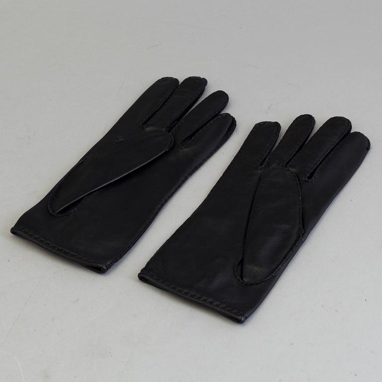 A pair of black lambskin gloves by Hermès.