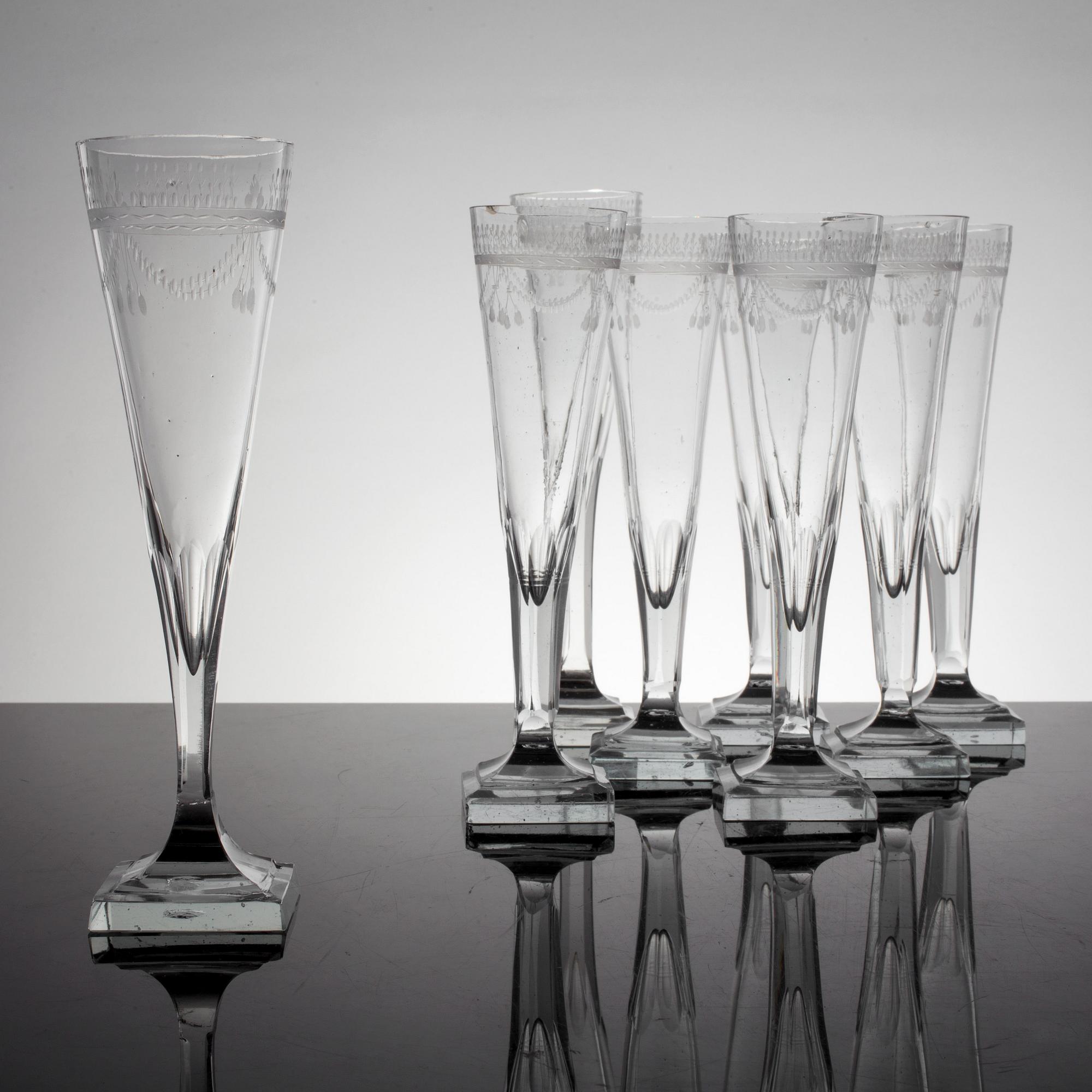 A set of 8 early 19th century champagne glasses.