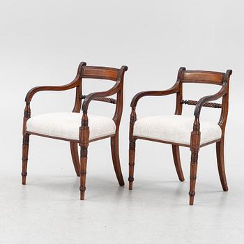 A set of 10 mahogany chairs and 2 armchairs, Regency style, from around the year 1900.