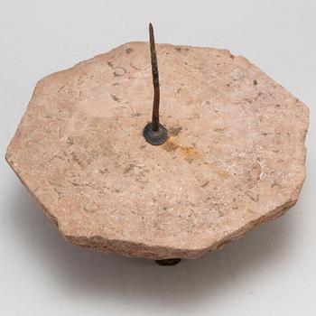A limestone and iron sundial dated 1732.