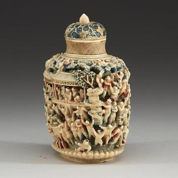 A deeply carved ivory snuff bottle with cover, China, early 20th Century.