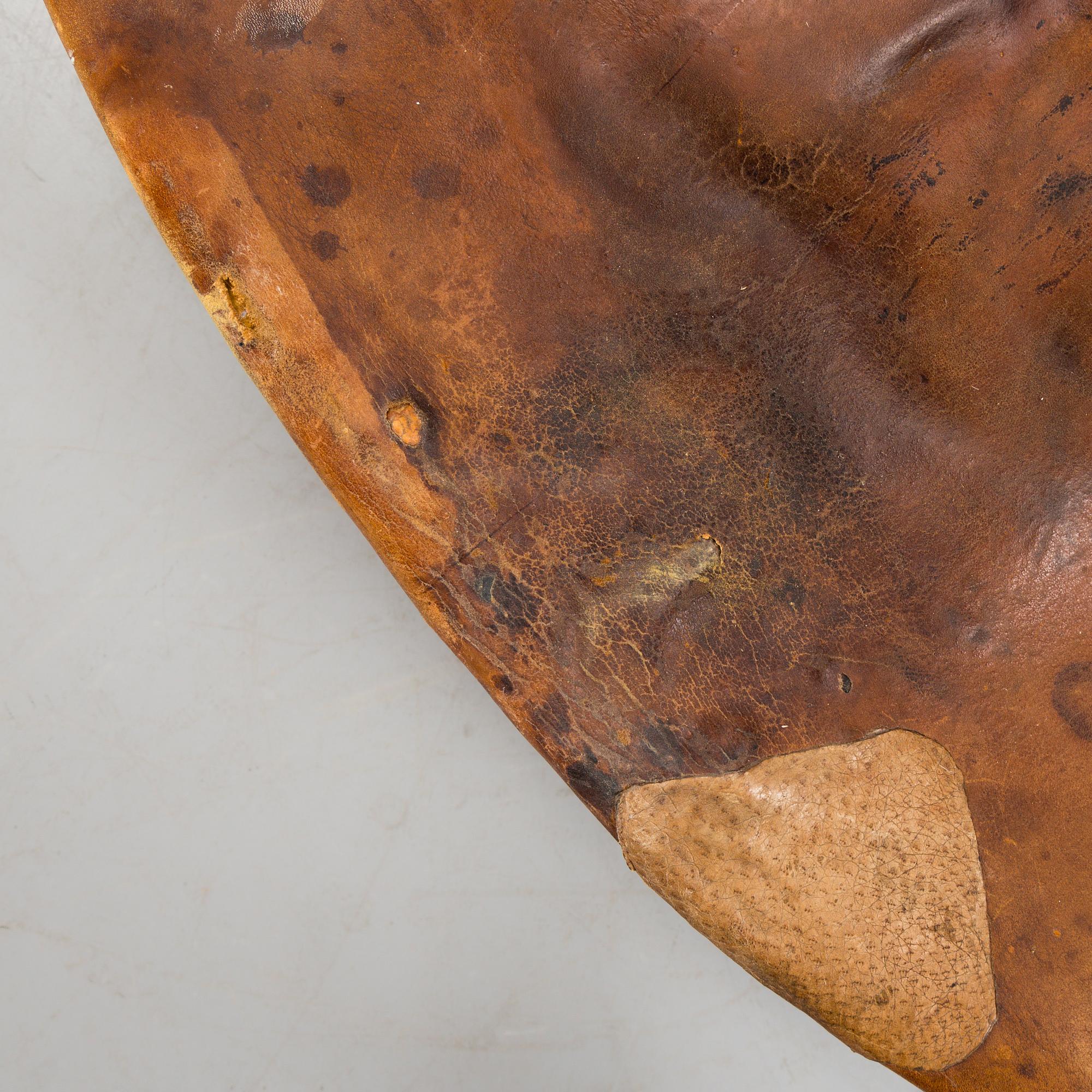 An Arne Jacobsen steel and brown leather 'Swan' chair, Fritz Hansen, Denmark 1960's.