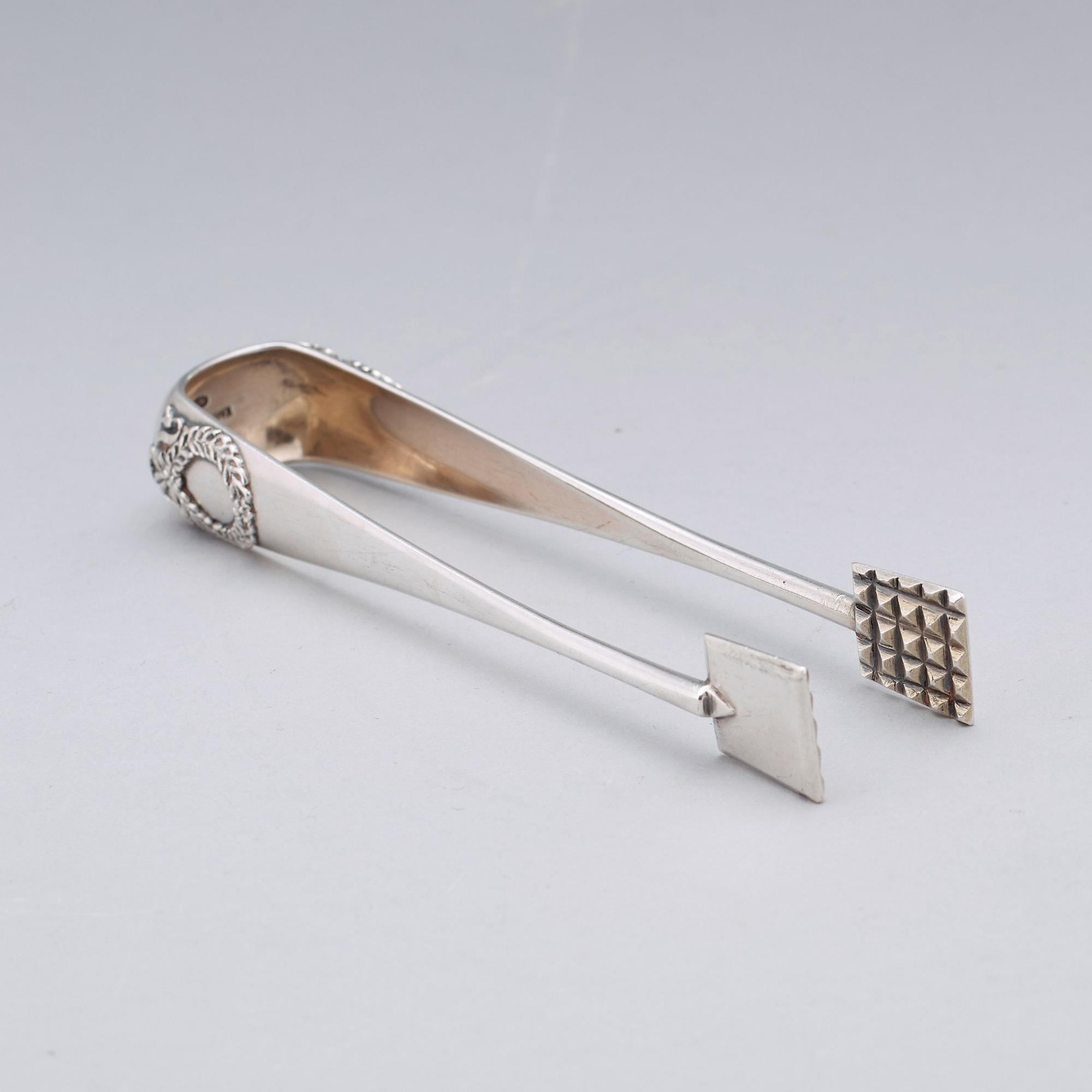 A Fabergé 20th century silver sugar-tongs, work master Anders Michelsen 1908-1917. Imperial Warrant.